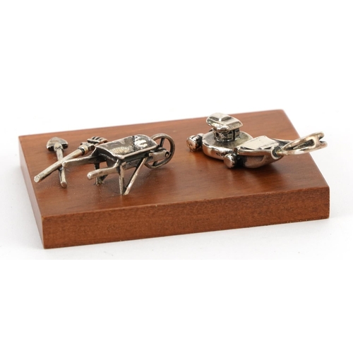 232 - Miniature Italian silver diorama of a lawnmower, wheelbarrow, rake and spade and a silver model of a... 