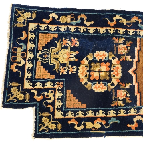 1030A - Chinese blue ground Saddle rug decorated with Daoist emblems and flowers, 120cm x 53cm