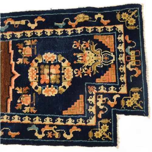 1030A - Chinese blue ground Saddle rug decorated with Daoist emblems and flowers, 120cm x 53cm