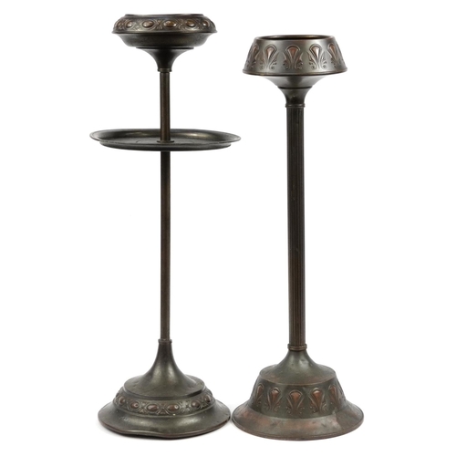 1032 - Two Dutch Art Nouveau copper floor standing smoker's stands, impressed marks to the bases, the large... 