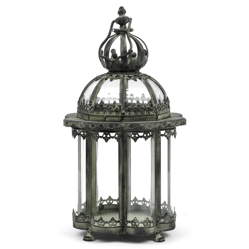 539 - Bronzed metal hanging lantern with glass panels on paw feet, 45.5cm high