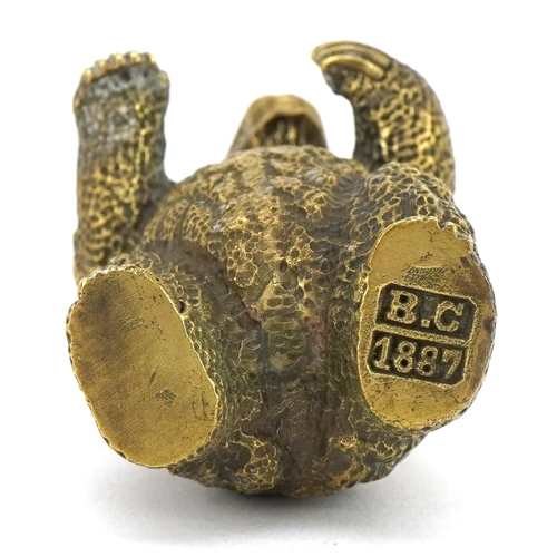 1268 - Novelty brass vesta case in the form of a bear with inset ruby eyes, impressed marks to the base, 6.... 