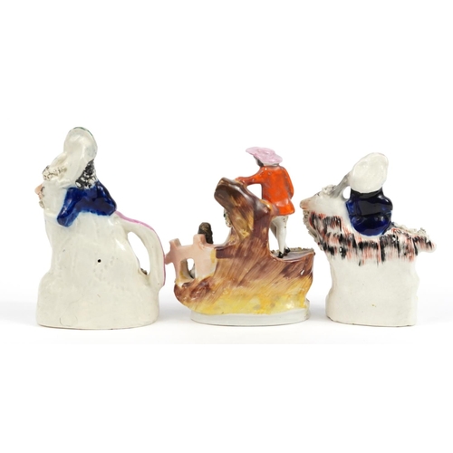 549 - Three Victorian Staffordshire figures including a courting couple and figure on horseback, the large... 