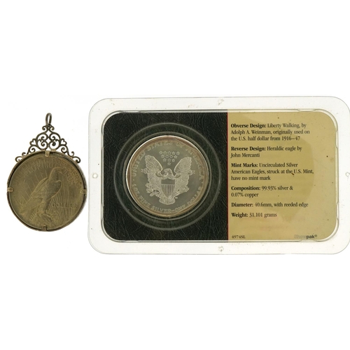 2452 - United States of America 2002 silver eagle and a 1922 dollar housed in a silver pendant mount