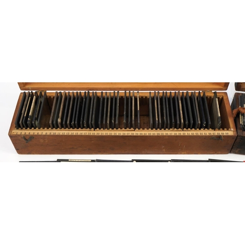 2474 - Collection of 19th century glass slides arranged in two pine cases, predominantly black and white an... 