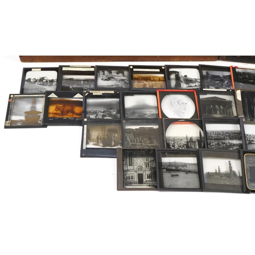 2474 - Collection of 19th century glass slides arranged in two pine cases, predominantly black and white an... 