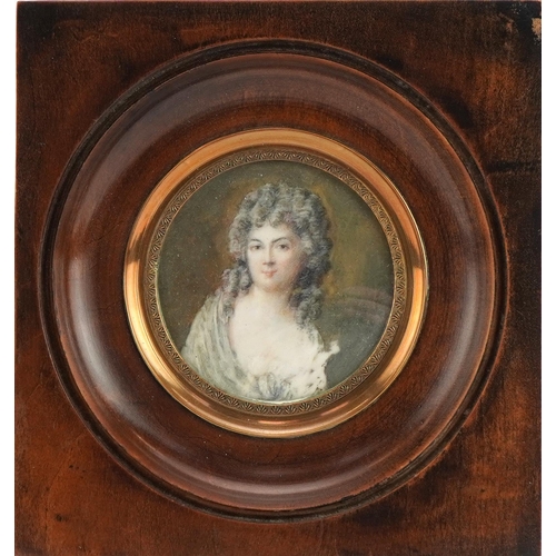 221 - Circular hand painted portrait miniature of a young female wearing a wig, mounted, framed and glazed... 