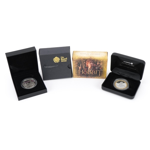 2437 - Two silver proof coins with cases and boxes including ten Z silver proof coin commemorating The Hobb... 