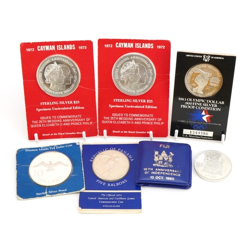 2412 - Six silver coins including two 1972 Cayman Islands twenty five dollars, 1983 Olympic dollar and 1970... 