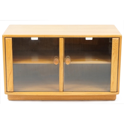 1041 - Ercol light elm multi media stand with glass doors, 55.5cm H x 91cm W x 44cm D