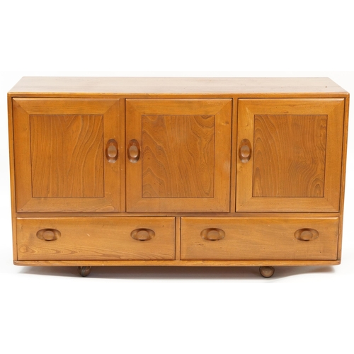 1005 - Ercol Windsor 468 light elm sideboard fitted with three doors above two drawers, 76cm H x 129.5cm W ... 