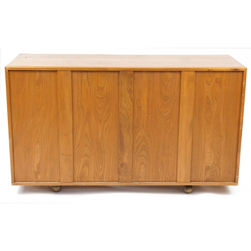 1005 - Ercol Windsor 468 light elm sideboard fitted with three doors above two drawers, 76cm H x 129.5cm W ... 