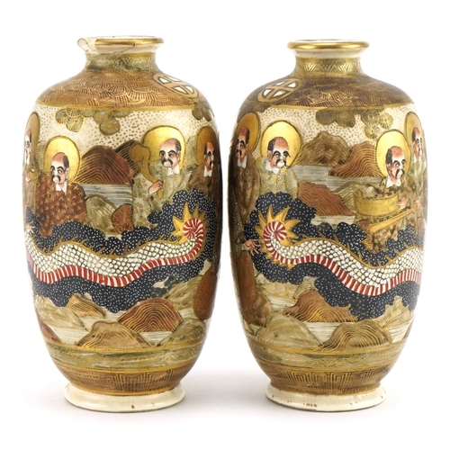 83 - Pair of Japanese Satsuma pottery vases housed in a silk lined fitted case, each hand painted with im... 