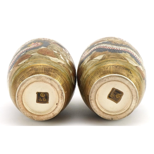 83 - Pair of Japanese Satsuma pottery vases housed in a silk lined fitted case, each hand painted with im... 