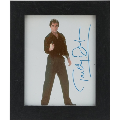 2484 - James Bond interest photograph of Timothy Doulton, signed in ink, framed and glazed, overall 32cm x ... 