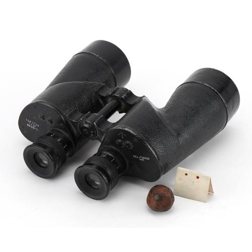 2181 - Pair of military interest World War II binoculars and a World War I nut carved with palm trees