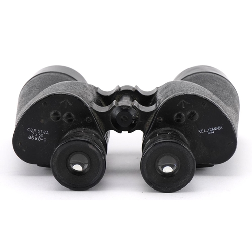 2181 - Pair of military interest World War II binoculars and a World War I nut carved with palm trees