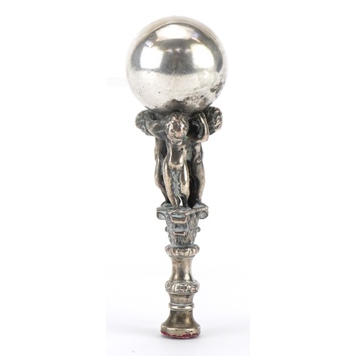 468 - Victorian silver plated desk seal in the form of three cherubs holding a ball aloft, 12cm high