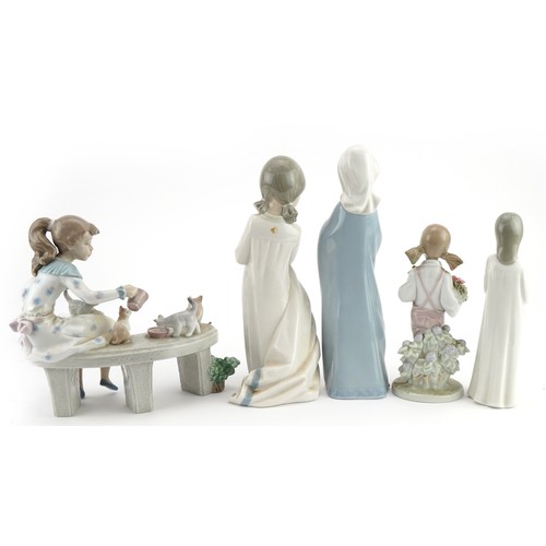 1216A - Four Lladro and Nao porcelain figurines and one similar including numbers 6109 and 5217, the largest... 