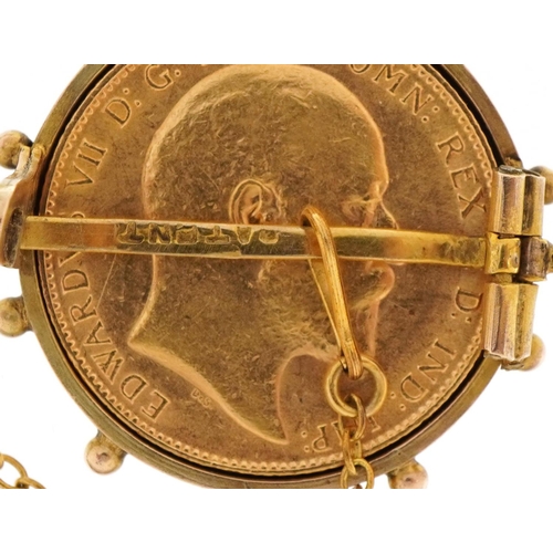 3042 - Edward VII 1910 gold sovereign housed in a 9ct gold brooch mount with safety chain, 2.7cm in diamete... 