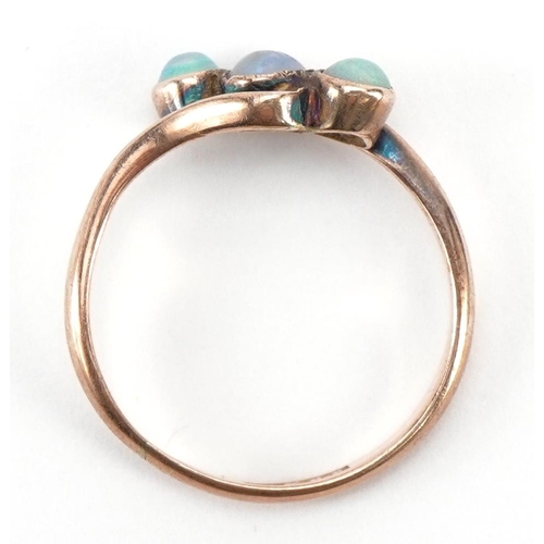 3051 - 9ct rose gold cabochon opal three stone crossover ring, size M, 1.8g