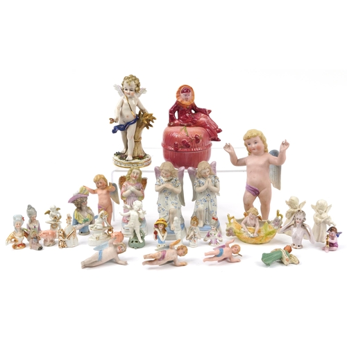 1440 - Continental porcelain, mostly bisque, including cherub decorations and half pin dolls