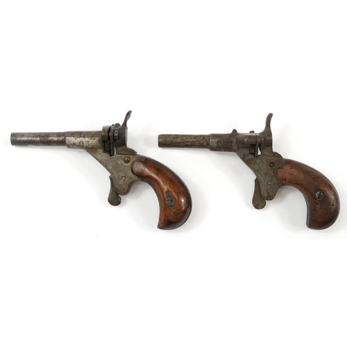 873 - Pair of antique steel percussion starting pistols with wooden stocks, 11cm in length