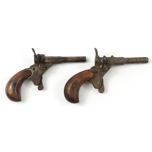 873 - Pair of antique steel percussion starting pistols with wooden stocks, 11cm in length