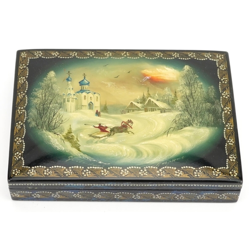 1432 - Russian lacquered card box having a hinged lid hand painted with a Cossack, 15cm wide