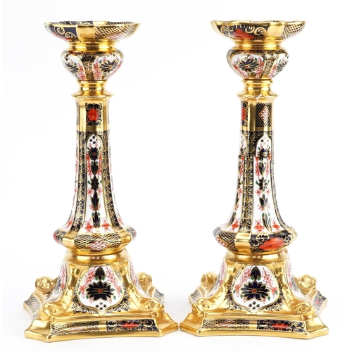 185 - Pair of Royal Crown Derby Old Imari pattern candlesticks numbered 1128, each 27cm high