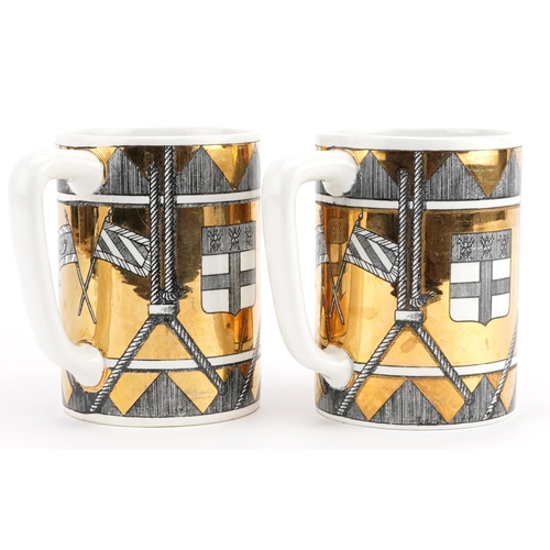 251 - Fornasetti, pair of vintage Italian gold lustre mugs decorated with shields, each 12.5cm high