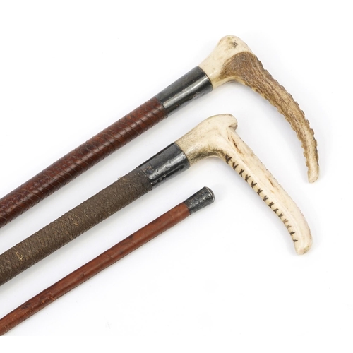 120 - Three Edwardian and later leather riding crops with silver mounts, two with horn handles