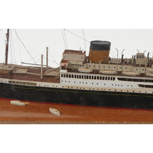 289 - Hand painted scratch built model of an ocean liner housed in a glazed oak display case, overall 64cm... 