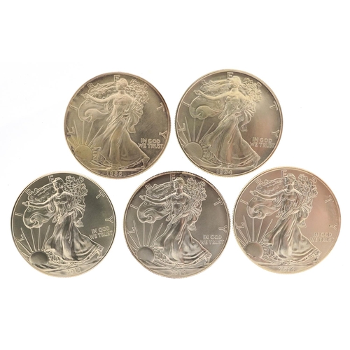 646 - Five United States of America one ounce silver dollars comprising dates 1986, 1994, 2014, 2014 and 2... 