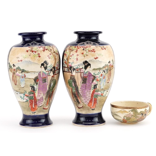 1282 - Pair of Japanese Satsuma pottery vases and a cup hand painted with figures in a landscape, the vases... 