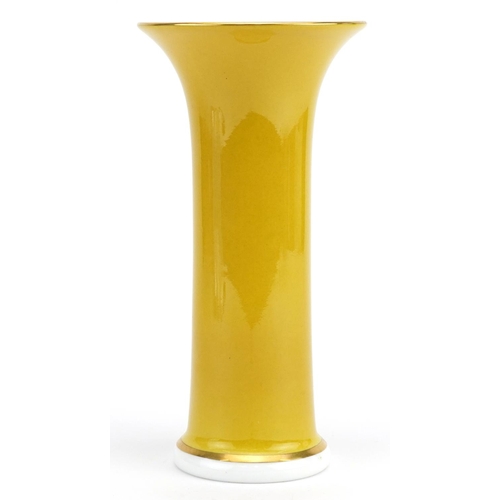 284 - Caverswall yellow ground porcelain trumpet vase hand painted with flowers, 19.5cm high