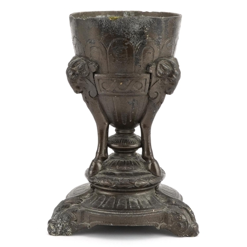 1354 - Classical patinated metal centrepiece with rams heads, 23.5cm high