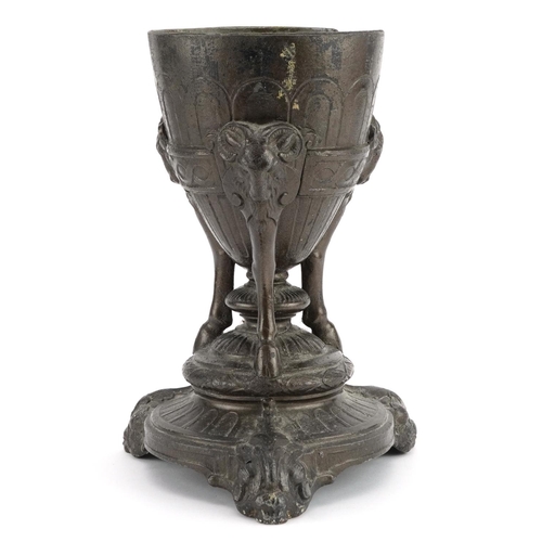 1354 - Classical patinated metal centrepiece with rams heads, 23.5cm high