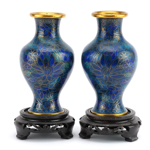 1312 - Pair of Chinese cloisonne vases raised on hardwood stands enamelled with flowers, each overall 16cm ... 