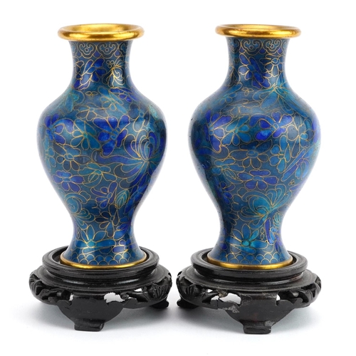 1312 - Pair of Chinese cloisonne vases raised on hardwood stands enamelled with flowers, each overall 16cm ... 