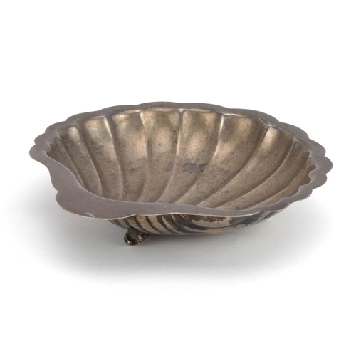 166 - Egyptian shell shaped silver dish raised on three feet, 12cm in length, 79.4g