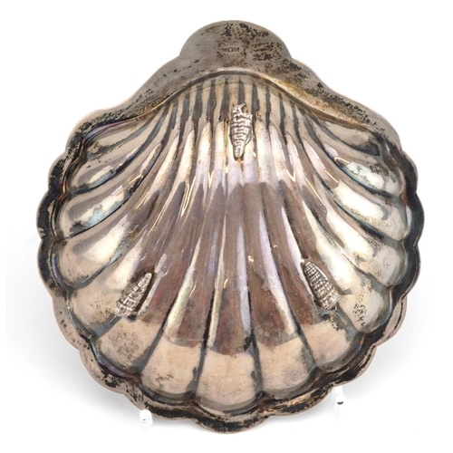 166 - Egyptian shell shaped silver dish raised on three feet, 12cm in length, 79.4g