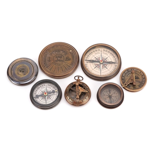 1300 - Four nautical interest compasses, one with perpetual calendar, the largest 7.5cm in diameter