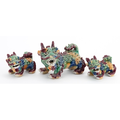 1430 - Three Chinese porcelain New Year dragons having Sangxi type glazes, the largest 13cm wide