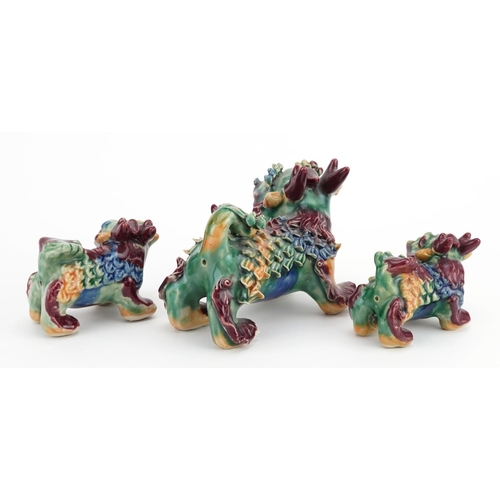 1430 - Three Chinese porcelain New Year dragons having Sangxi type glazes, the largest 13cm wide