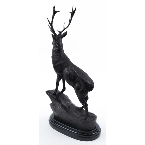 110 - Large patinated bronze stag raised on a black marble base, 73cm high