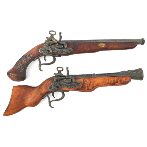 877 - Two wooden and metal model guns comprising a blunderbuss and a flintlock pistol, the largest 47cm in... 