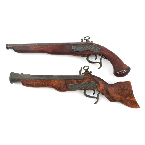 877 - Two wooden and metal model guns comprising a blunderbuss and a flintlock pistol, the largest 47cm in... 