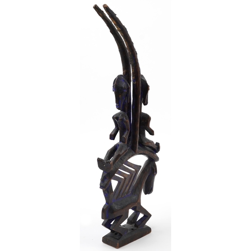 136 - African tribal interest Dogon tribe carving of two figures on an animal back, 65cm high