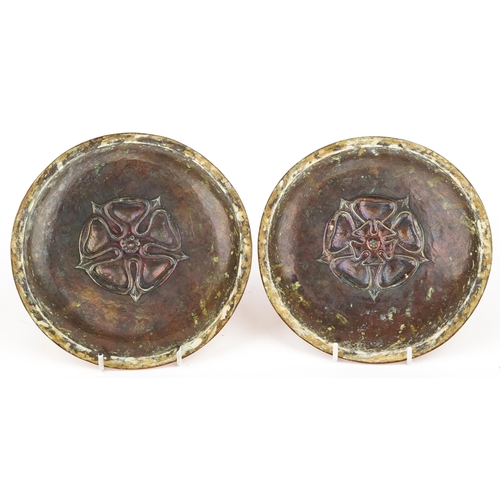 161 - Manner of Newlyn, pair of Arts & Crafts planished copper dishes, each embossed with a Tudor rose, ea... 